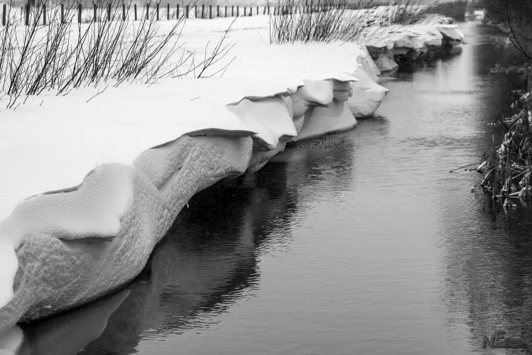 Snow down the ditch side.