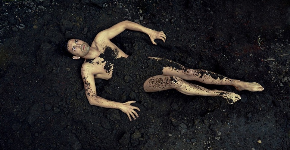 Naakte man in de modder.